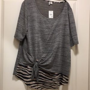 A beautiful women blouse, size XL, colors are gray  bland and cream